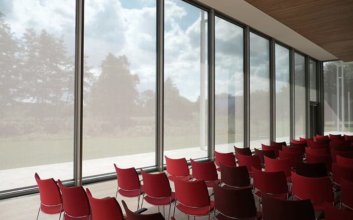 Classroom with red chairs and large windows